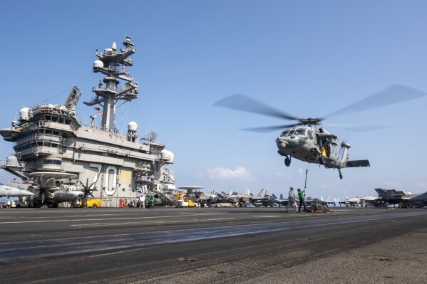 This photograph released by the U.S. Navy shows a MH-60S Sea Hawk helicopter hovering over the USS Carl Vinson aircraft carrier while operating in the Middle East April 12, 2025. (Petty Officer 3rd Class Nathan Jordan/U.S. Navy via AP, File)