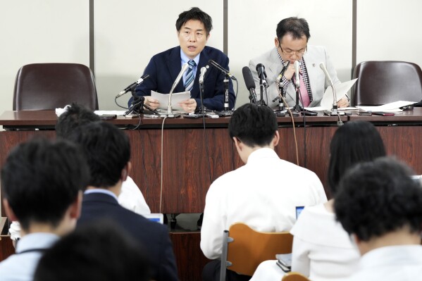 Lawyers of a claimant, Kazuyuki Minami, left, and Masafumi Yoshida, right, speak to media after the ruling of the Supreme Court Wednesday, Oct. 25, 2023, in Tokyo. Japan’s Supreme Court on Wednesday ruled that a law requiring transgender people to have sterilization surgery in order to officially change their gender is unconstitutional.(AP Photo/Eugene Hoshiko)