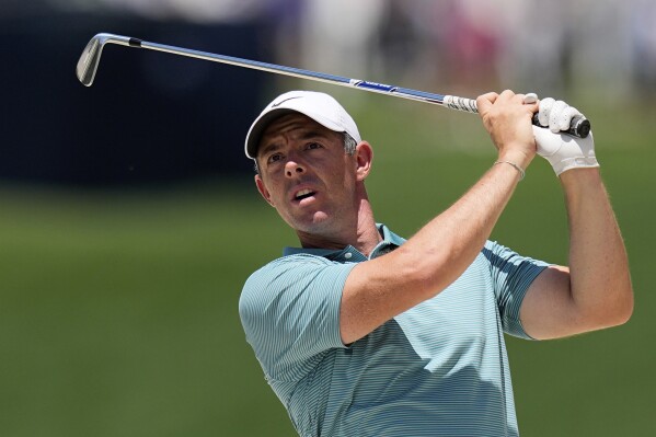 Rory McIlroy, of Northern Ireland, hits from the rough on the 10th hole during a practice round for the PGA Championship golf tournament at the Quail Hollow Club, Wednesday, May 14, 2025, in Charlotte, N.C. (AP Photo/David J. Phillip)