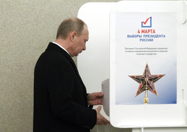 FILE - Russian Prime Minister and presidential candidate Vladimir Putin casts his ballot in Moscow on Sunday, March 4, 2012. Voting in Russia's 2024 presidential elections will take place over three days between March 15-17. It is the first presidential election in Russia when polls will be open for three days instead of one. (AP Photo/Misha Japaridze, Pool, File)
