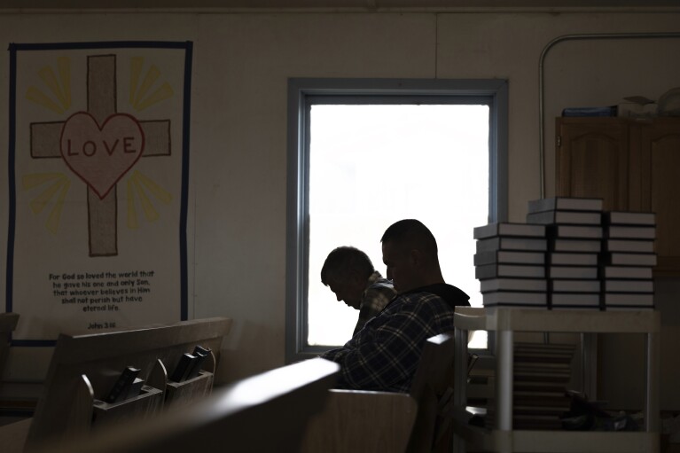 Churchgoers bow their heads during prayer inside the Akiachak Moravian Church, Sunday, Aug. 20, 2023, in Akiachak, Alaska. (AP Photo/Tom Brenner)