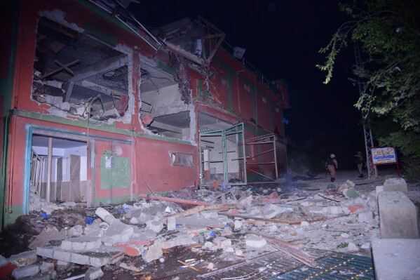 Army soldiers examine a building damaged by a suspected Indian missile attack near Muzaffarabad, the capital of Pakistan controlled Kashmir, in Wednesday, May 7, 2025. (AP Photo/M.D. Mughal)