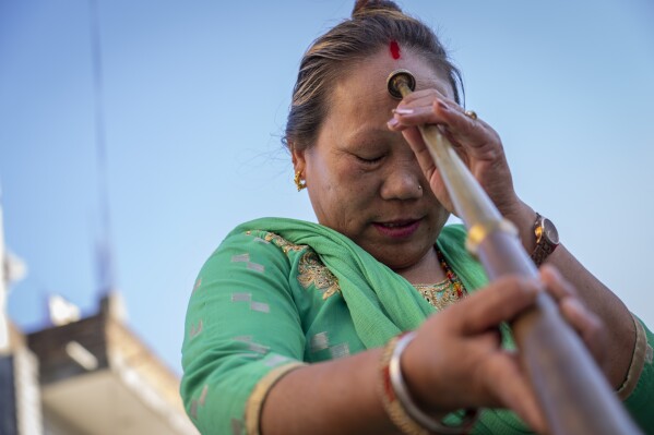 Maya Ghale, 48, worships her instrument before a rehearsal of the Shrijanshil Mahila Sanstha, or the Self-Reliant Women’s Group, in Kathmandu, Nepal, Tuesday, March 5, 2024. (AP Photo/Niranjan Shrestha)
