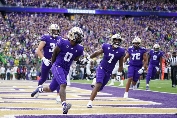 Washington wide receiver Giles Jackson (0) celebrates after scouring a touchdown against Oregon during the first half of an NCAA college football game, Saturday, Oct. 14, 2023, in Seattle. (AP Photo/Lindsey Wasson)
