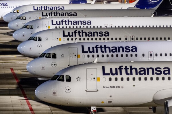 FILE - Lufthansa aircrafts are parked at the airport in Frankfurt, Germany, Wednesday, Feb. 7, 2024. A union has called on ground staff for Lufthansa at seven German airports to walk off the job for a day on Tuesday, following a similar strike earlier this month. The Ver.di union said Sunday that the strike will affect Frankfurt and Munich, Lufthansa's two main hubs, as well as Berlin, Duesseldorf, Hamburg, Cologne-Bonn and Stuttgart. (AP Photo/Michael Probst, File)