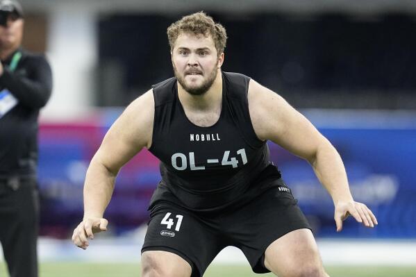 FILE - Northwestern offensive lineman Peter Skoronski runs a drill at the NFL football scouting combine in Indianapolis, Sunday, March 5, 2023. Skoronski looks like a custom-built NFL offensive lineman. (AP Photo/Darron Cummings, File)