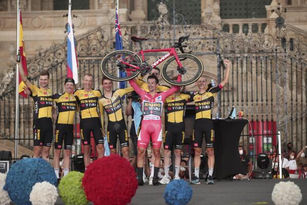 Race winner Primoz Roglic celebrates with Team Jumbo-Visma riders at the end of a time trial on the 21st and last stage of the Vuelta Cycling race in Santiago, Spain, Sunday, Sept. 5, 2021. (AP Photo/Luis Vieira)
