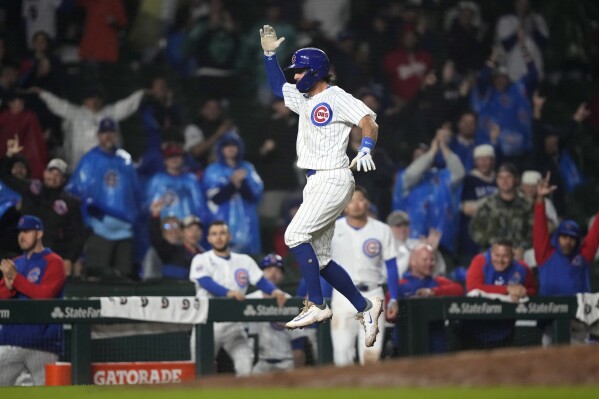 Chicago Cubs' Dansby Swanson celebrates his two-run home run against the Cincinnati Reds during the eighth inning of a baseball game early Sunday, June 2, 2024, in Chicago. (AP Photo/Charles Rex Arbogast)