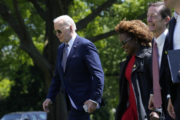 President Joe Biden, from left, walks with White House press secretary Karine Jean-Pierre and White House deputy chief of staff Bruce Reed, as they cross the South Lawn of the White House in Washington, Friday, April 26, 2024, after returning from a trip to New York. (AP Photo/Susan Walsh)