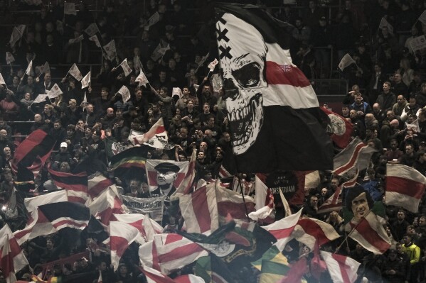 Ajax's fans wave flags before the Europa League group B soccer match between Ajax and Brighton and Hove Albion at the Johan Cruyff ArenA stadium in Amsterdam, Netherlands, Thursday, Nov. 9, 2023. (AP Photo/Patrick Post)