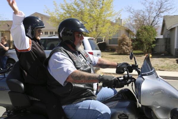 Velma Thornburgh, known locally as "Motorcycle Mama," celebrates her 102nd birthday with a ride on the back of a Harley Davidson on April 10, 2022 in Dayton, Nev.   Her daughter, Sandra Bell, 77, organized the trip and reached out to Harmon for help. (Jessica Garcia/Nevada Appeal via AP)