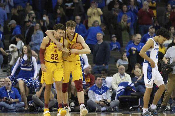 Iowa State's Gabe Kalscheur (22) and Aljaž Kunc (5) celebrate their 64-58 victory over Creighton as Ryan Nembhard (2) exits the court in an NCAA college basketball game Saturday, Dec. 4, 2021, at CHI Health Center in Omaha, Neb. Iowa State defeated Creighton 64-58. (AP Photo/Rebecca S. Gratz)