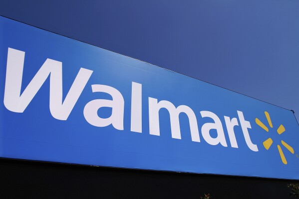 FILE - The Walmart logo is displayed on a store in Springfield, Ill., May 16, 2011. Walmart plans to build or convert more than 150 U.S. stores in the next five years, while continuing to remodel existing stores. The plan, announced Wednesday, Jan. 31, 2024 marks a big change for the discounter. (AP Photo/Seth Perlman, File)