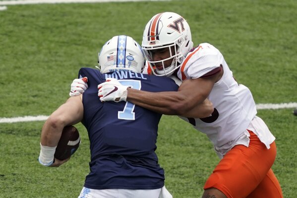 Virginia Tech linebacker Amare Barno rushes North Carolina quarterback Sam Howell (7) during the first half of an NCAA college football game in Chapel Hill, N.C., Saturday, Oct. 10, 2020. (AP Photo/Gerry Broome)