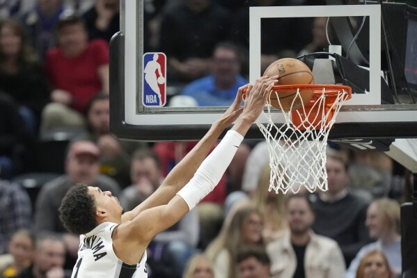 San Antonio Spurs center Victor Wembanyama (1) dunks against the Utah Jazz during the first half of an NBA basketball game Wednesday, March 27, 2024, in Salt Lake City. (AP Photo/Rick Bowmer)