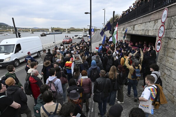 Supporters of the political party Momentum stage a protest in Budapest, Monday, April 14, 2025 after Hungary’s parliament has passed an amendment to the constitution that allows the government to ban public events by LGBTQ+ communities. (Tibor Illyes/MTI via AP)