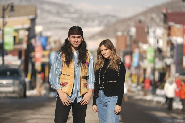 Julian Brave NoiseCat, left, and Emily Kassie, co-directors of the Oscar-nominated documentary film "Sugarcane," pose for a portrait on Main Street during the Sundance Film Festival on Monday, Jan. 27, 2025, in Park City, Utah. (AP Photo/Chris Pizzello)