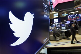 FILE - In this Feb. 8, 2018 file photo, the logo for Twitter is displayed above a trading post on the floor of the New York Stock Exchange.  Twitter says, Tuesday, June 23, 2020,  it will give its U.S. employees Election Day off going forward and employees around the world a paid day off to vote in national elections. In addition, if employees don't have enough time to vote outside of working hours in their country, the company says it will compensate them for the time it takes to do so. (AP Photo/Richard Drew, File)