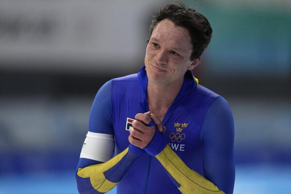 FILE- Nils van der Poel of Sweden reacts after breaking his own world record in the men's speedskating 10,000-meter race at the 2022 Winter Olympics, Friday, Feb. 11, 2022, in Beijing. Back in Sweden with his two gold medals in speedskating, the speedskater told the Aftonbladet newspaper that although he had “a very nice experience behind the scenes,” hosting the Games in China was “terrible.” He drew parallels with the 1936 Summer Olympics in Nazi Germany and Russia hosting the Sochi Olympics before seizing control of the Crimean peninsula in 2014. (AP Photo/Ashley Landis, File)