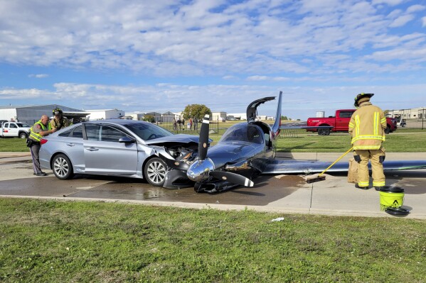 This photo provided by the McKinney Fire Department shows officials at the site of a crash involving a small plane and a vehicle near Aero Country Airport, Saturday, Nov. 11, 2023, in McKinney, Texas. Authorities say a small plane overshot the runway while trying to land at a Texas airport and struck a car that was driving along a nearby road, injuring one person. (McKinney Fire Department via AP)