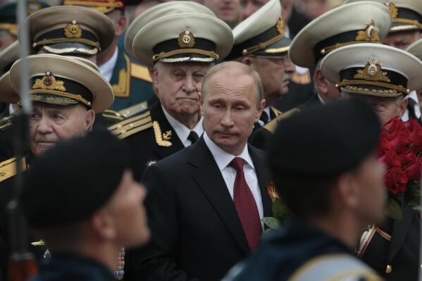 Russian President Vladimir Putin attends a parade marking the Victory Day in Sevastopol, Crimea, Friday, May 9, 2014. Presiding over a triumphant spectacle of warships and fighter jets, Putin hailed the return of Crimea to Russia as the restoration of "historic justice" before a jubilant, welcoming crowd Friday on the holiday that Russians hold dearest to their hearts. (AP Photo/Ivan Sekretarev)