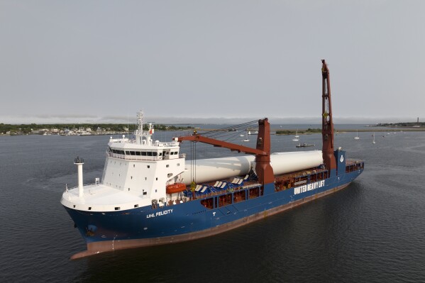 FILE - The ship UHL Felicity, carrying parts for offshore wind turbines, arrives to dock May 24, 2023, in New Bedford, Mass. The joint owners of the Vineyard Wind project, Avangrid and Copenhagen Infrastructure Partners, announced Wednesday, Jan. 3, 2024, the first electricity from one turbine at what will be a 62-turbine wind farm 15 miles (24 kilometers) off the coast of Massachusetts. (AP Photo/Rodrique Ngowi, File)