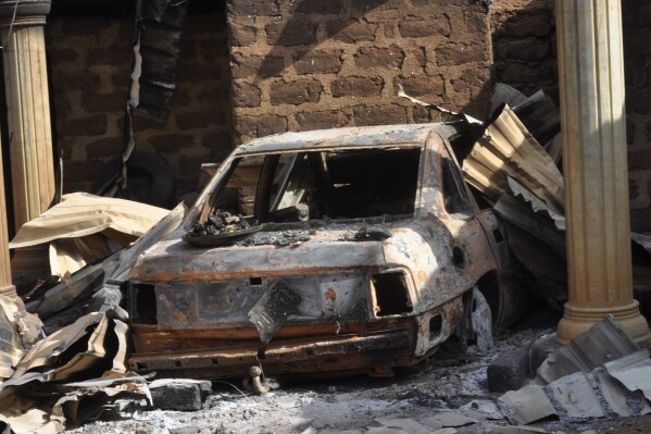 A burnt out car is seen following an attacked by gunmen in Bokkos, north central Nigeria, Tuesday, Dec. 26, 2023. Nigerian officials and survivors say at least 140 people were killed by gunmen who attacked remote villages in north-central Nigeria's Plateau state in the latest of such mass killings this year blamed on the West African nation's farmer-herder crisis. (AP Photo)