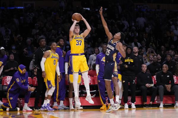 Los Angeles Lakers forward Matt Ryan (37) shoots and make a 3-point shot to send the game to overtime as New Orleans Pelicans guard Trey Murphy III defends during the second half of an NBA basketball game Wednesday, Nov. 2, 2022, in Los Angeles. (AP Photo/Mark J. Terrill)