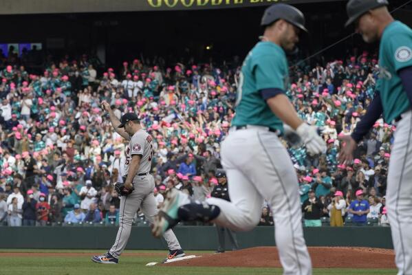 Seattle Mariners' Kyle Lewis, left, is greeted by Taylor Trammell