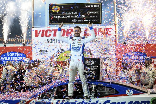 Kyle Larson (5) celebrates in Victory Lane after winning the NASCAR All-Star Cup Series auto race at North Wilkesboro Speedway, Sunday, May 21, 2023, in North Wilkesboro, N.C. (AP Photo/Matt Kelley)