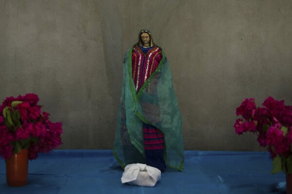 A Virgin of Guadalupe statue adorns an altar in the Simojovel municipality, Mexico, Saturday, April 26, 2025. (AP Photo/Isabel Mateos)
