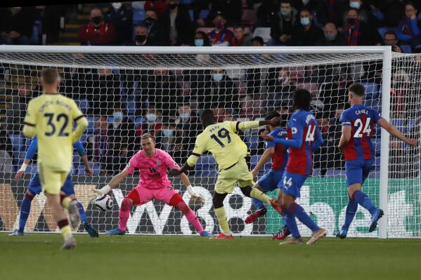 Arsenal's Nicolas Pepe, center, scores his side's third goal during the English Premier League soccer match between Crystal Palace and Arsenal, at Selhurst Park in London, England, Wednesday, May 19, 2021. (Frank Augstein, Pool)