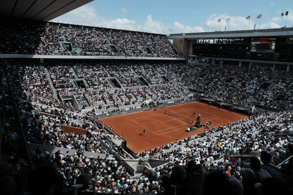 The crowd watch Norway's Casper Ruud playing Spain's Rafael Nadal on the court Philippe Chatrier, known as center court, during their final match of the French Open tennis tournament at the Roland Garros stadium Sunday, June 5, 2022 in Paris. The Roland Garros stadium will host the tennis competitions during the Paris 2024 Olympic Games. (Ǻ Photo/Thibault Camus, File)