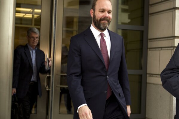 
              Rick Gates leaves federal court in Washington, Friday, Feb. 23, 2018. Gates, a former top adviser to President Donald Trump's campaign pleaded guilty in the special counsel's Russia investigation to federal conspiracy and false statements charges. (AP Photo/Jose Luis Magana)
            
