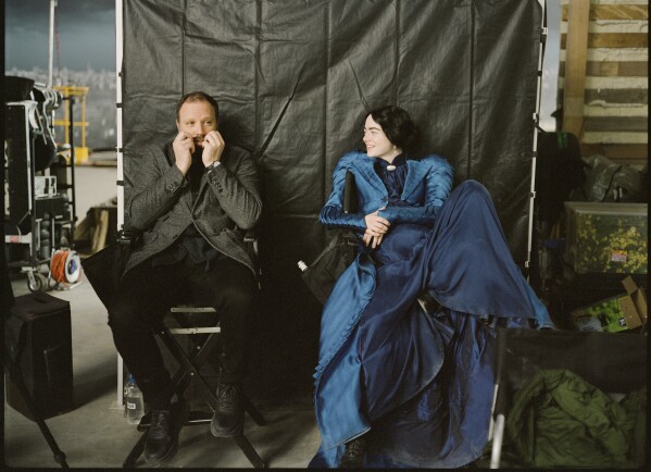This image released by Searchlight Pictures shows Yorgos Lanthimos and Emma Stone on the set of 