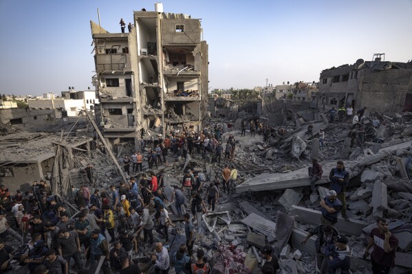 Palestinians look for survivors of the Israeli bombardment in the Maghazi refugee camp in the Gaza Strip, Sunday, Nov. 5, 2023. (AP Photo/Fatima Shbair)