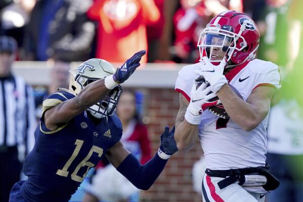 Georgia wide receiver Jermaine Burton (7) makes a catch for a touchdown as Georgia Tech defensive back Myles Sims (16) defends in the first half of an NCAA college football game Saturday, Nov. 27, 2021, in Atlanta. (AP Photo/John Bazemore)