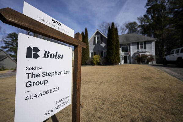 A sign announcing the sale of a home is shown on Thursday, Feb. 1, 2024, in Kennesaw, Ga., near Atlanta. On Thursday, Feb. 22, 2024, the National Association of Realtors reports on existing home sales for January. (AP Photo/Mike Stewart)