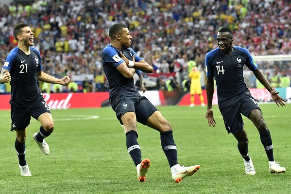 FILE - France's Kylian Mbappe, center, celebrates after scoring his side's fourth goal during the final match between France and Croatia at the 2018 soccer World Cup in the Luzhniki Stadium in Moscow, Russia, Sunday, July 15, 2018. Mbappe has told Paris Saint-Germain he will leave the club at the end of the season, it was reported on Thursday, Feb. 15, 2024. (AP Photo/Martin Meissner, File)