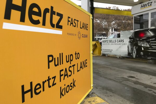 
              In this Friday, Dec. 7, 2018, photo, a Hertz "Fast Lane" sign directs rental car drivers to a biometric scanning machine at Hartsfield-Jackson Atlanta International Airport, in Atlanta. In a first for the rental car industry, Hertz is teaming up with Clear, the maker of biometric screening kiosks found at many airports and stadiums. Hertz says the partnership will slash the time it takes to pick up a rental car. (AP Photo/Jeff Martin)
            