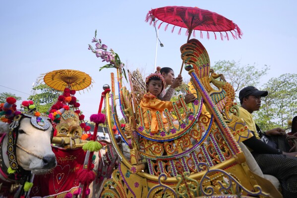 Children who are to become Buddhist nuns ride on decorated cow carts during a processional parade as part of a celebration of a novitiation or “Shinbyu,” ceremony, Saturday, March 15, 2025, at Hlegu township, outside of Yangon, Myanmar. (AP Photo/Thein Zaw)