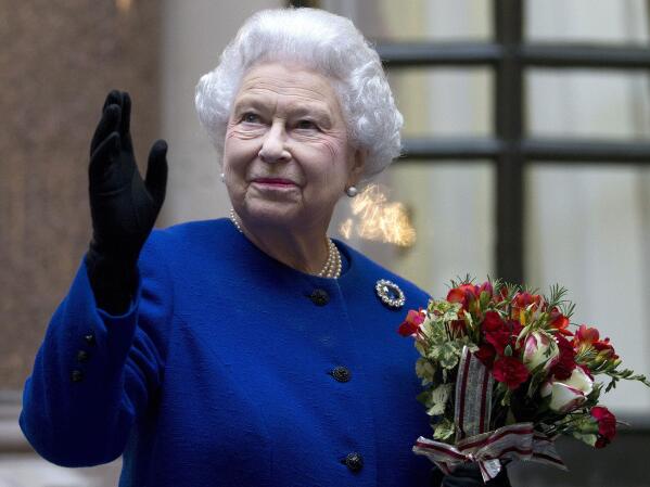 FILE - In this Tuesday, Dec. 18, 2012 file photo, Britain's Queen Elizabeth II looks up and waves to members of staff of The Foreign and Commonwealth Office as she ends an official visit which is part of her Jubilee celebrations in London. Queen Elizabeth II, Britain’s longest-reigning monarch and a symbol of stability across much of a turbulent century, has died on Thursday, Sept, 8, 2022. She was 96. (AP Photo/Alastair Grant Pool, File)