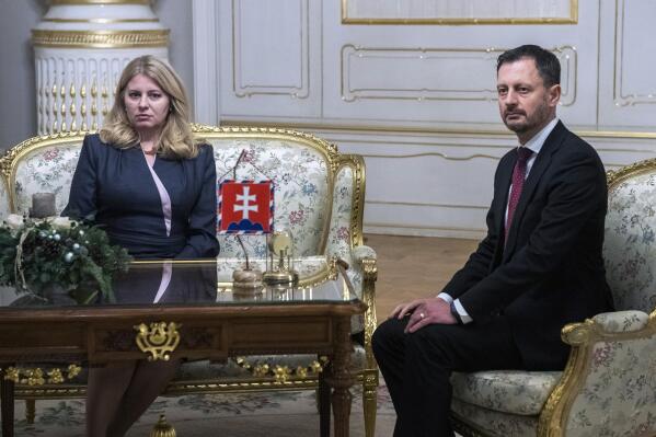 Slovakia's Prime Minister Eduard Heger (OLANO), rigth, meets Slovakia's President Zuzana Caputova, after Parliament in a vote expressed no-confidence in his Government at the Presidential Palace, in Bratislava, Thursday, Dec. 15, 2022. Slovakia's coalition government has fallen after losing a parliamentary no-confidence vote Thursday, a move that could lead to an early election. (Jaroslav Novak/TASR via AP)