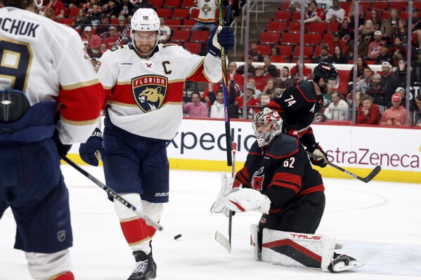 Florida Panthers' Aleksander Barkov, right, celebrates his goal with Florida Panthers' Matthew Tkachuk (19) as Carolina Hurricanes goaltender Pyotr Kochetkov (52) looks on during the third period of Game 2 of the NHL hockey Stanley Cup Eastern Conference finals in Raleigh, N.C., Thursday, May 22, 2025. (AP Photo/Karl DeBlaker)