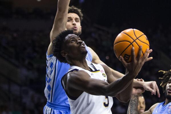 Notre Dame's Trey Wertz (3) drives past North Carolina's Pete Nance, back, during the second half of an NCAA college basketball game Wednesday, Feb. 22, 2023, in South Bend, Ind. (AP Photo/Michael Caterina)