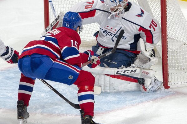 Washington Capitals goaltender Braden Holtby (70) stops Montreal Canadiens centre Jesperi Kotkaniemi (15) during second period NHL hockey action Monday, Jan. 27, 2020 in Montreal. (Ryan Remiorz/The Canadian Press via AP)