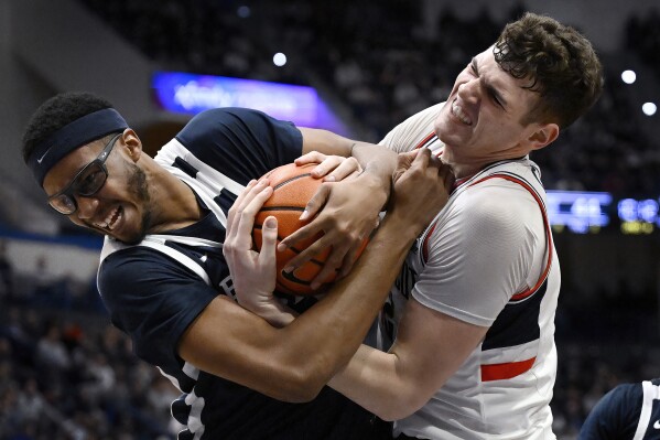 Butler center Andre Screen, left, and UConn center Donovan Clingan wrestle for the ball in the second half of an NCAA college basketball game, Tuesday, Feb. 6, 2024, in Hartford, Conn. (AP Photo/Jessica Hill)