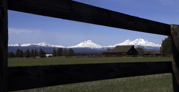 A view of four our central Oregon Cascade Mountain Range peaks, from left, Broken Top, South Sister, Middle Sister and North Sister, as seen from near Sisters, Ore., April 24, 2018. (AP Photo/Don Ryan, File)