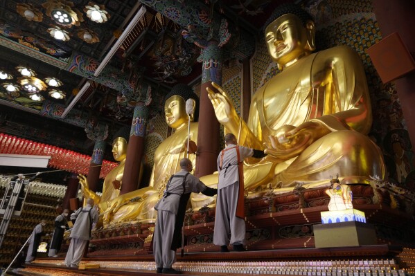 Buddhists monks clean Buddha statues ahead of the upcoming birthday of Buddha on May 15, at the Jogye temple in Seoul, South Korea, Tuesday, May 7, 2024. (Ǻ Photo/Ahn Young-joon)