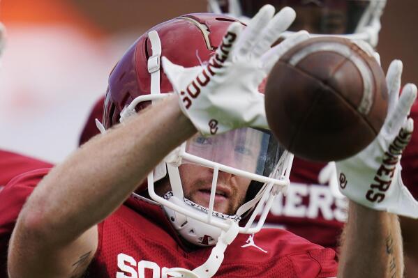 FILE - Oklahoma's Drake Stoops catches a pass during the NCAA college football team's practice Tuesday, Aug. 16, 2022, in Norman, Okla. Stoops is one of many Big 12 players who are in the running for the Burlsworth Trophy, which names the nation's top player who starts his career as a walk-on.(AP Photo/Sue Ogrocki, File)